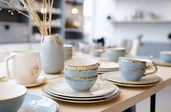 porcelain ceramic pastel colors with gold white cream blue hand-made colored ceramic tableware on the counter in the store porcelain ceramic pastel colors with gold white cream blue hand-made colored ceramic tableware on the counter in the store